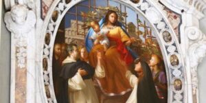 dipinto della Madonnna del Rosario e santi in una cornice ovale con motivi di losangeh in marmi colorati