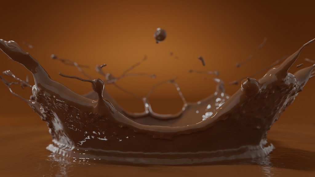 una goccia di cioccolata cade su un tavolo 