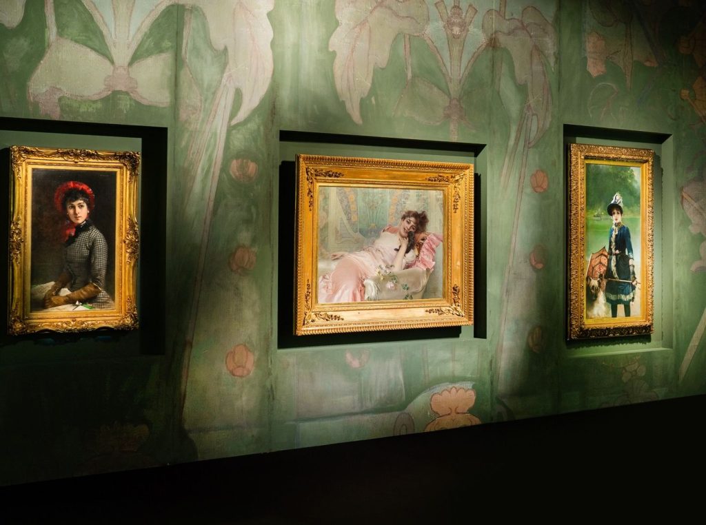 tre quadri appesi ad una parete con una decorazione verde